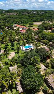 an aerial view of a resort with a pool at Porto do Sol - Chalé 25 in Pipa