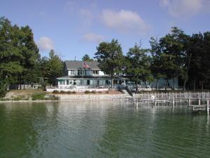 a house on the shore of a body of water at Churchill Pointe Inn in Hubbard Lake