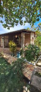 a brick house with a brick walkway in front of it at Porto do Sol - Chalé 07 in Pipa