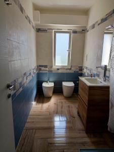 a bathroom with two sinks and two toilets at Solleone - Appartamento 9C in Paestum +23 photos