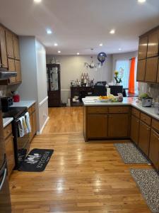 a kitchen with wooden cabinets and a wooden floor at Berni Oasis in Hampton