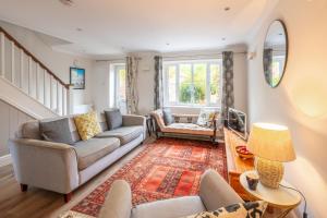 a living room with two couches and a rug at 2 Mallard Cottages 4 in Tattersett