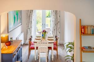 a dining room with a table and chairs and a window at 2 Mallard Cottages 4 in Tattersett