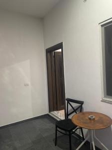 a room with a table and a chair and a door at Durrës Beach Apartments in Durrës +8 photos