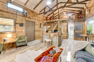 a living room with a couch and a table at Lake Eufaula Access Cozy Wood Cabin with Yard! in Coates