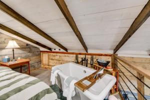 a bathroom with a bed and a tub in a room at Lake Eufaula Access Cozy Wood Cabin with Yard! in Coates +26 photos