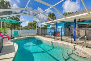a large swimming pool with a pool at Fenced Yard, Game Room Family Home in Sebastian! in Sebastian