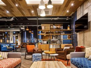 a lobby with couches and chairs and a table at ibis Budget Sheffield Centre St Marys Gate in Sheffield