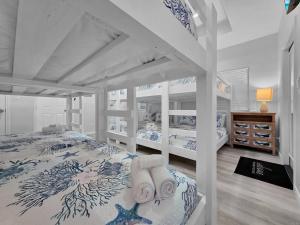 a white bedroom with two bunk beds in it at Pooldreamz! Beachfront Heated Salt Pool! Sleep24! in Caplen +111 photos