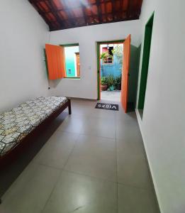 a room with a bed and an open door at Casa Bromélia in Lençóis