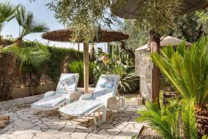 a patio with two chairs and an umbrella at Casa-Villa en Lorca relax vistas y piscina privada in Lorca