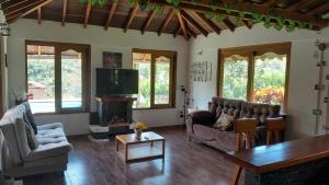 a living room with two couches and a tv at Hermosa Casa de campo cerca a Yolombo, las partidas in Yolombó