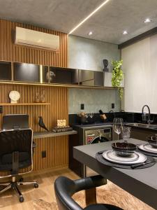 a kitchen with a table and chairs in a room at Anmu experiencie in Montes Claros