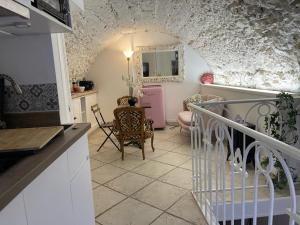 a kitchen with a staircase leading to a living room at Duplex apartment in La Celle-sous-Gouzon