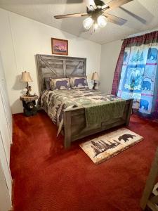 a bedroom with a bed and a ceiling fan at Black Bear Hideaway in Pickens