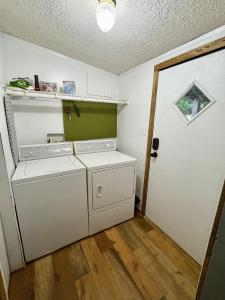 a laundry room with a washer and dryer next to a door at Black Bear Hideaway in Pickens +25 photos