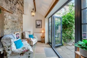 a living room with a stone wall at Eastgate House Alnwick in Alnwick