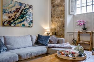 a living room with a couch and a table at Eastgate House Alnwick in Alnwick