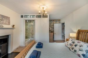 a living room with a couch and a fireplace at Eastgate House Alnwick in Alnwick