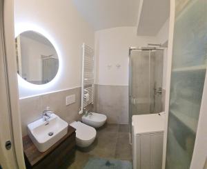 a bathroom with a sink and a toilet and a shower at Mountain View Room in Milan +19 photos