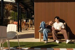 a man and a woman sitting on a bench at Little Drifter Glebe in Sydney