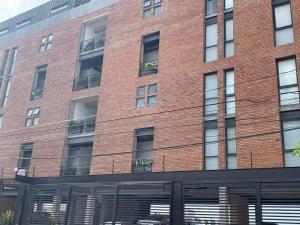 un edificio de ladrillo rojo con muchas ventanas en Brick Box Studio con Terraza, en Hércules 3 fotos más