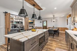 a kitchen with a large island and a dining room at Aska Acres in Greens Mill