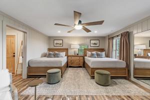a bedroom with two beds and a ceiling fan at Aska Acres in Greens Mill