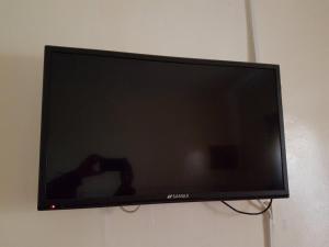 a flat screen tv hanging on a wall at Boiketlo Lodge Gaborone in Gaborone