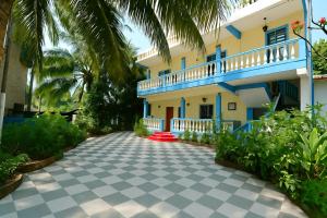 a villa with a driveway in front of a house at Kalash Apartments with Kitchen in Calangute