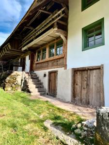 an old house with wooden doors and windows at Ferienhaus Hederle in Elzach