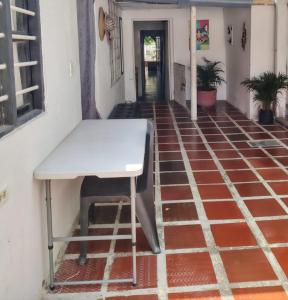 a white table sitting on a red tile floor at Casa yamulemao in Cartagena de Indias
