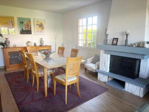 a dining room with a table and a fireplace at Maison Villa Sables-d'Olonne in Les Sables-d'Olonne