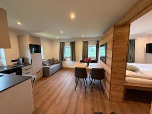 a bedroom with a bed and a kitchen with a table at Panorama Lodge Bergblick in Salzburg