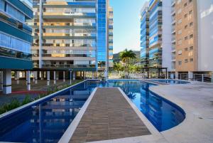 a swimming pool in a city with tall buildings at Boulevard Praia de Palmas a 400m do Mar - GCR009 in Governador Celso Ramos
