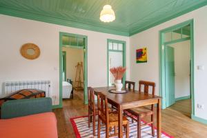 a dining room with a table and chairs at Casa Alba, desde 1926 in Alvados +28 photos