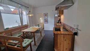 a kitchen with a table and a sink and a table and chairs at Aasee Apartments in Münster