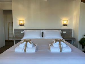 a bed with two towels and two lights on it at Under The Tuscan Sun in Arezzo