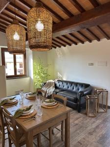 a living room with a table and a leather couch at Under The Tuscan Sun in Arezzo