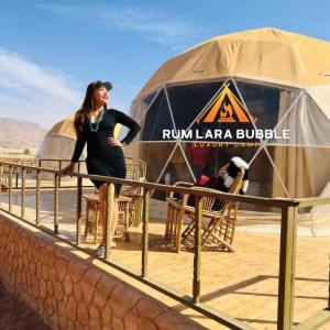 a woman standing in front of a yurt at RUM LARA BUBBLES lUXURY CAMP in Wadi Rum