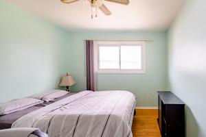 a bedroom with two beds and a window at Bungalow in a Quiet Neighborhood in Waterloo