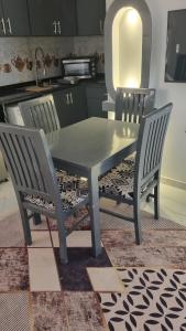 a dining table and two chairs in a kitchen at Villa Saeed in Al Karnak