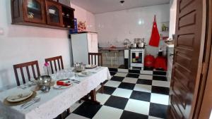 a kitchen with a black and white checkered floor at Quarto suite master para 3 pessoas in Belém