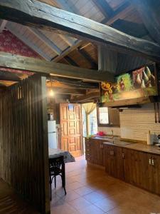 a kitchen with wooden cabinets and a table in it at Casa Folibar in Manzanedo de Valdueza