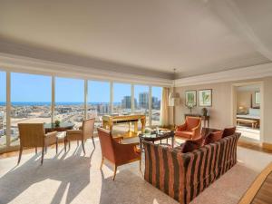 a living room with a couch and a table at Mövenpick Hotel Al Khobar in Al Khobar