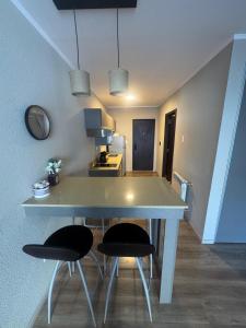 a kitchen with a table and two chairs in a room at Apart Pm Casa de playa in Necochea +11 photos