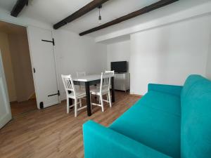 a living room with a couch and a table and chairs at Casa Petracca in Muggia