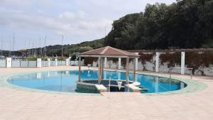a swimming pool with a gazebo in the middle at Floating House - LUXURY Floating Sea OASIS Pula in Pula