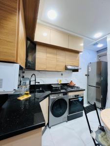 a kitchen with a washing machine and a stove at Modern Apartment Bouznika in Bouznika