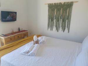 a bedroom with two towel animals on a bed at Bracciera Lipsi Apts 3 in Lipsoi